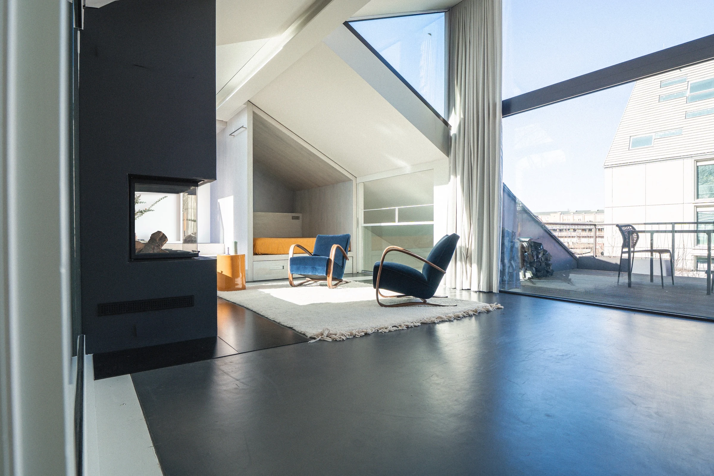 Upper floor with fireplace and armchair by the roof window