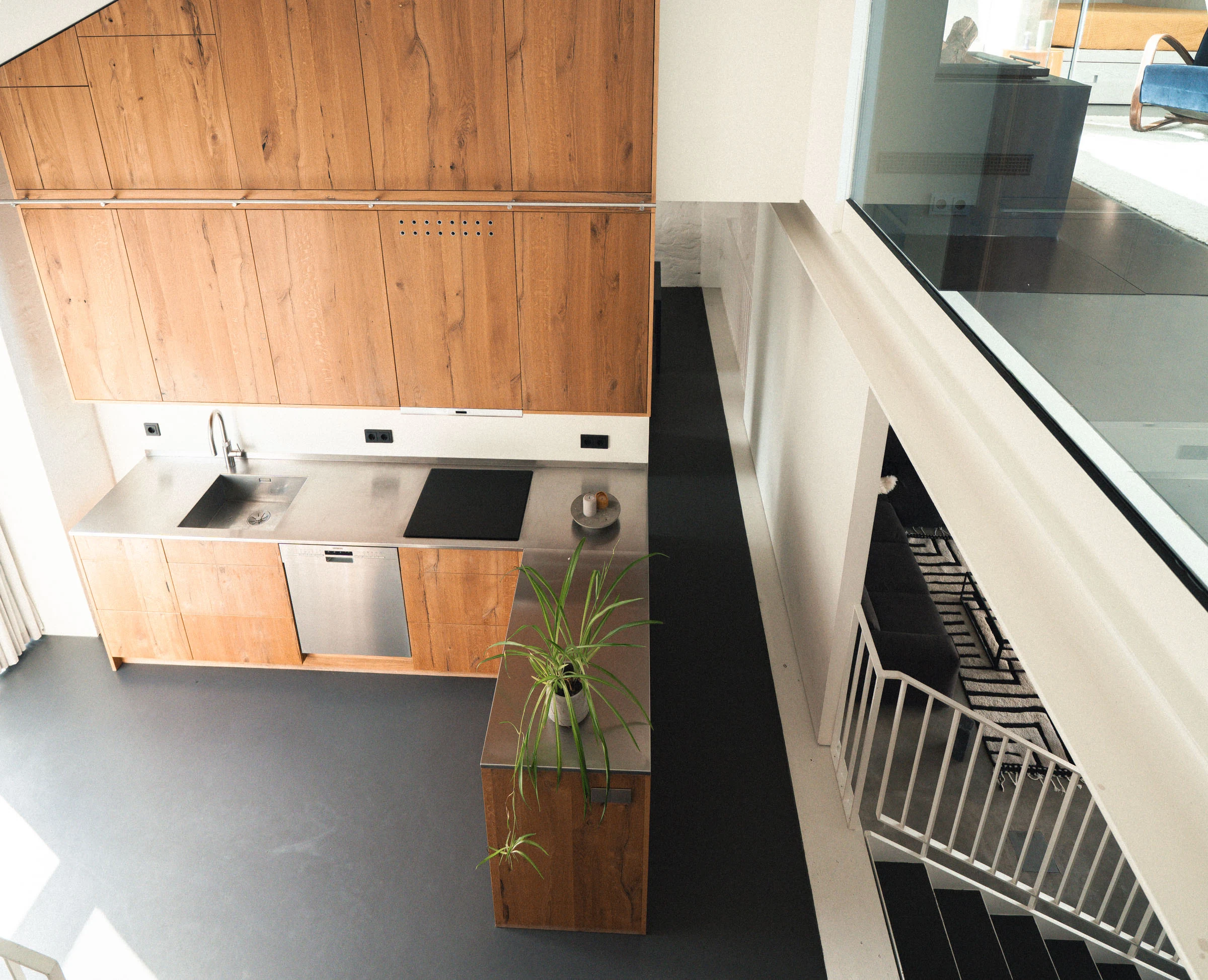 Kitchen with wooden cabinets seen from the stairs