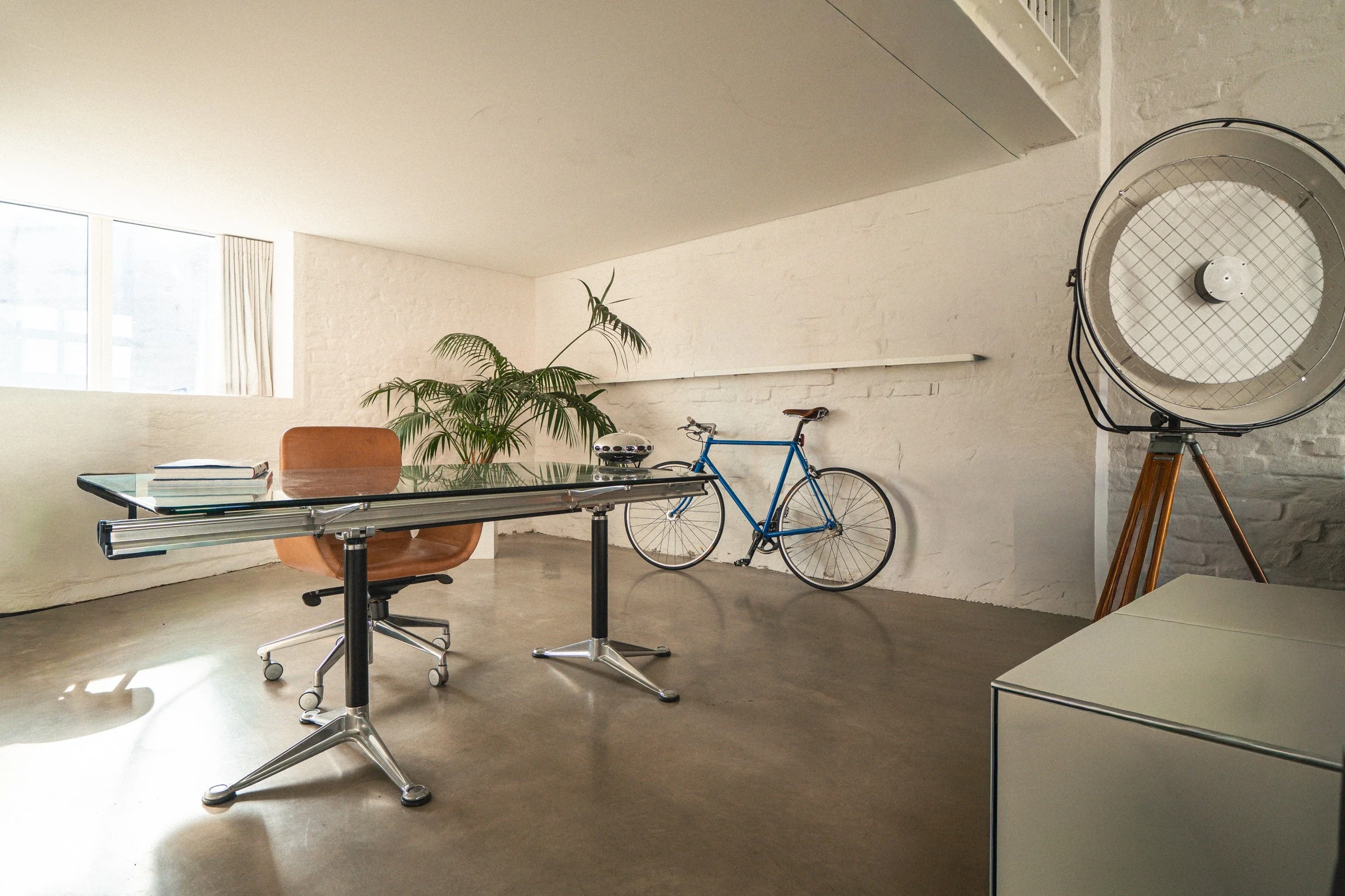 Desk with vintage studio light and bicycle